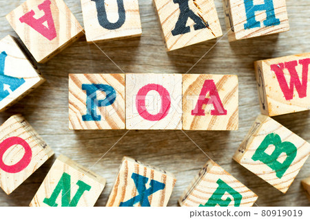 Alphabet letter block in word POA (Abbreviation of Plan of action, Power of attorney, Period of availability or Paid on arrival) with another on wood background 80919019