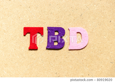 Color cloth alphabet letter in word TBD (Abbreviation of to be defined, discussed, determined, decided, deleted or declared) on wood background 80919020
