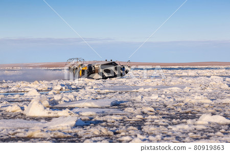 Airboat crosses river estuary is covered by ice floes Airboat crosses river estuary is covered by ice floes 80919863