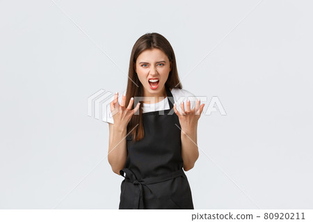 Grocery store employees, small business and coffee shops concept. Mad saleswoman complaining on rude customers, clench hands angry and grimacing angry, standing white background 80920211