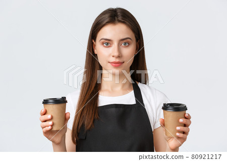 Employees, job employment, small business and coffee shop concept. Close-up of smiling friendly-looking female barista, cafe employee handling two cups of coffee order to client Employees, job employment, small business and coffee shop concept. Close-up of smiling friendly-looking female barista, cafe employee handling two cups of coffee order to client 80921217