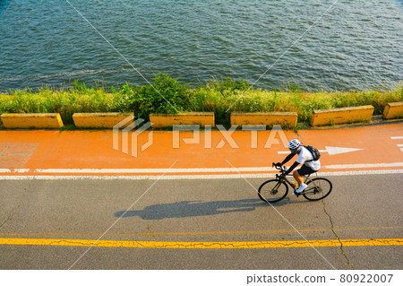 A bicycle rider riding along the Han River A bicycle rider riding along the Han River 80922007