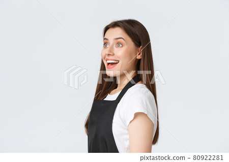 Employees, job employment, small business and coffee shop concept. Profile of barista,saleswoman in black apron react with excitement and surprise while looking left, white background 80922281