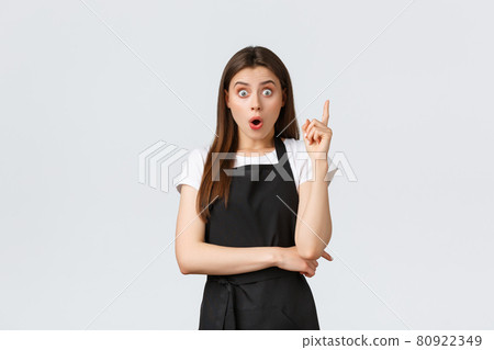 Small business, employees and coffee shop concept. Excited barista raising index finger as saying suggestion out loud. Creative saleswoman have plan. Waiter thinking-up solution Small business, employees and coffee shop concept. Excited barista raising index finger as saying suggestion out loud. Creative saleswoman have plan. Waiter thinking-up solution 80922349