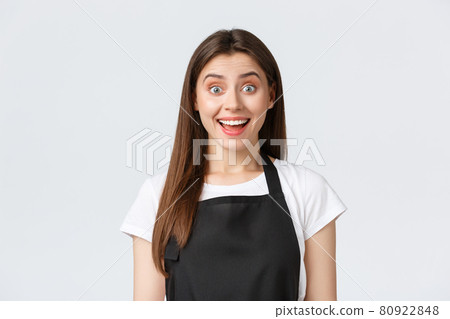 Employees, job employment, small business and coffee shop concept. Surprised and excited smiling barista, saleswoman in black apron react to great news, looking astonished 80922848