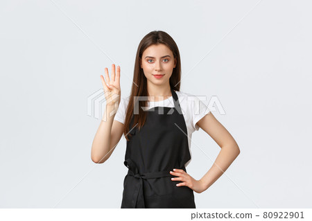 Grocery store employees, small business and coffee shops concept. Cheerful young female barista in black apron showing number four, smiling determined, working in cafe Grocery store employees, small business and coffee shops concept. Cheerful young female barista in black apron showing number four, smiling determined, working in cafe 80922901