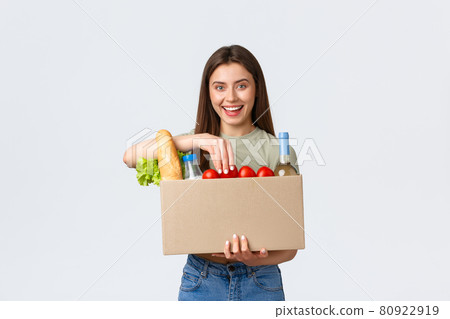 Online home delivery, internet orders and grocery shopping concept. Excited woman satisfied with quality of deliver service from local shop, holding groceries in box and smiling amazed 80922919
