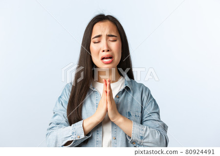 Lifestyle, people emotions and beauty concept. Desperate sad and clingy asian girl sobbing and crying while begging help, apologizing with hands in plead, telling how sorry she is 80924491