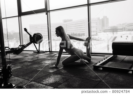 Beautiful muscular fit woman exercising, building muscles in gym Beautiful muscular fit woman exercising, building muscles in gym 80924784