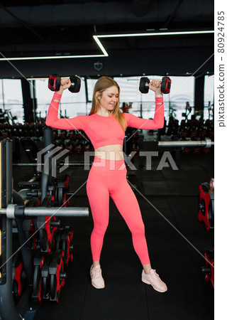 Beautiful muscular fit woman exercising, building muscles in gym Beautiful muscular fit woman exercising, building muscles in gym 80924785