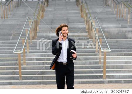 Portrait of an handsome businessman in the city. Portrait of an handsome businessman in the city. 80924787
