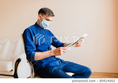 Man working on laptop wearing mask from home office Man working on laptop wearing mask from home office 80924802