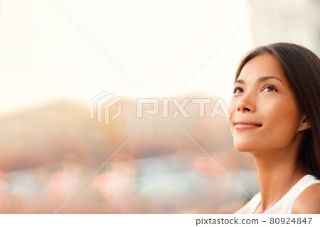 Happy young Asian woman natural beauty looking up pensive thinking of successful life and goal achievement, hopeful for the future career. Beautiful model with copy space 80924847