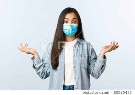 Social distancing lifestyle, covid-19 pandemic everyday life and leisure concept. Confused attractive asian woman in medical mask dont know, shrugging shoulders clueless Social distancing lifestyle, covid-19 pandemic everyday life and leisure concept. Confused attractive asian woman in medical mask dont know, shrugging shoulders clueless 80925435