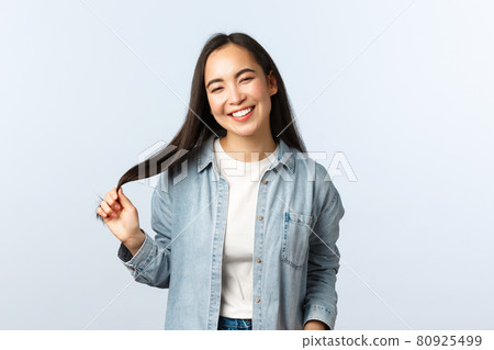 Lifestyle, people emotions and beauty concept. Carefree happy smiling outgoing woman. Asian girl laughing and touching hair, enjoying visit beauty salon, white background Lifestyle, people emotions and beauty concept. Carefree happy smiling outgoing woman. Asian girl laughing and touching hair, enjoying visit beauty salon, white background 80925499