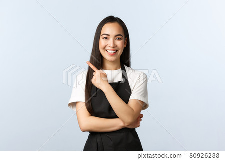 Coffee shop, small business and startup concept. Cheerful asian female working part-time at cafe, wear black apron, pointing finger upper left corner, inviting see banner or advertisement Coffee shop, small business and startup concept. Cheerful asian female working part-time at cafe, wear black apron, pointing finger upper left corner, inviting see banner or advertisement 80926288
