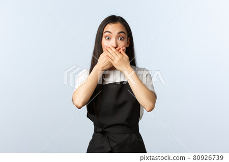 Coffee shop, small business and startup concept. Shocked startled asian barista cover mouth with hands and staring at camera astonished. Speechless female cafe staff react to unexpected news Coffee shop, small business and startup concept. Shocked startled asian barista cover mouth with hands and staring at camera astonished. Speechless female cafe staff react to unexpected news 80926739