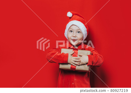 little boy holding christmas gift little boy holding christmas gift 80927219