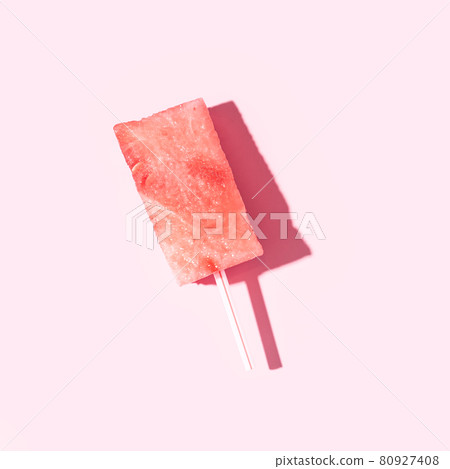 Straw is inserted into piece of ripe watermelon against pink background Straw is inserted into piece of ripe watermelon against pink background 80927408