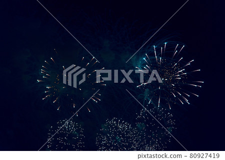 Blurred multicolored fireworks lights against the dark night sky 80927419
