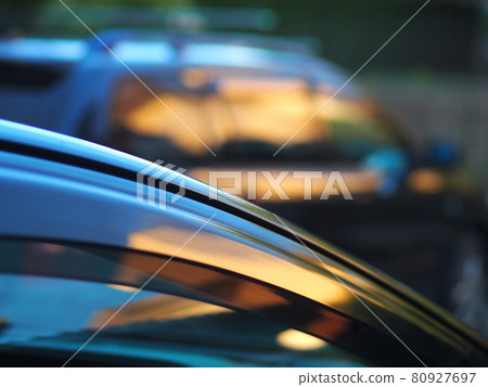 Sunset hitting a parked car 80927697