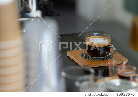 A cup of coffee on the table in the coffee shop A cup of coffee on the table in the coffee shop 80928676