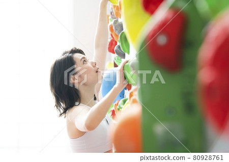 Young woman climbing gym Young woman climbing gym 80928761