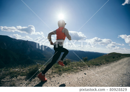 Young woman ultramarathon runner running at mountain top Young woman ultramarathon runner running at mountain top 80928829