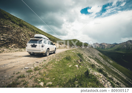 Driving off road car on high altitude mountain top 80930517
