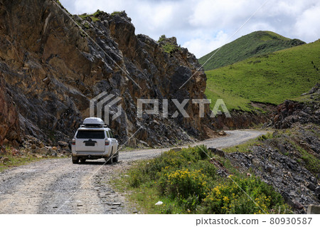 Driving off road car on high altitude mountain top 80930587