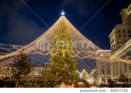 christmas tree in the center of town fair in night 80931788