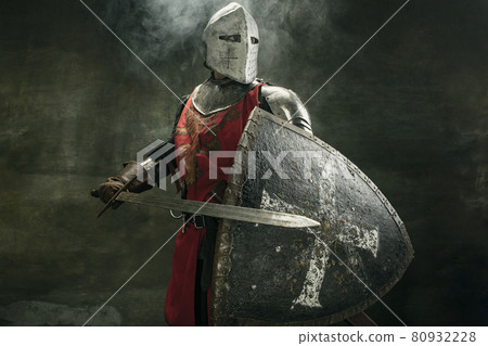 One medeival warrior or knight in armor and helmet with shield and sword 80932228