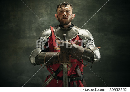 Portrait of one brutal bearded man, medeival warrior or knight with dirty wounded face Portrait of one brutal bearded man, medeival warrior or knight with dirty wounded face 80932262