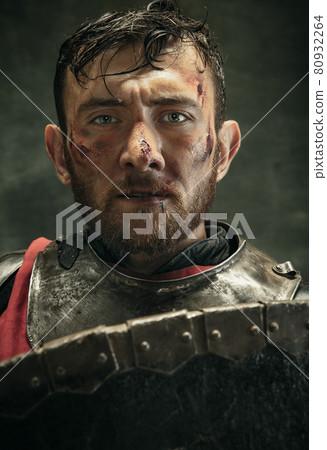 Portrait of one brutal bearded man, medeival warrior or knight with dirty wounded face Portrait of one brutal bearded man, medeival warrior or knight with dirty wounded face 80932264