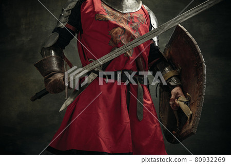 Cropped image. Portrait of one brutal man, medeival warrior or knight with sword and shield 80932269