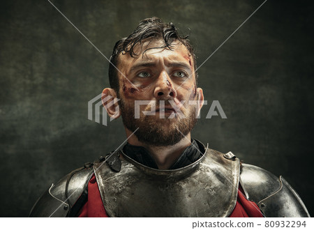 Portrait of one brutal bearded man, medeival warrior or knight with dirty wounded face Portrait of one brutal bearded man, medeival warrior or knight with dirty wounded face 80932294