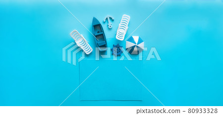 Blue envelope with sun lounger, beach umbrella, boat, anchor, steering wheel inside on a blue background 80933328