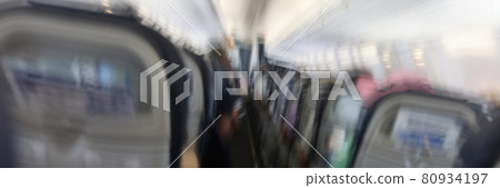 Passengers flying in aircraft cabin back view blurred background 80934197