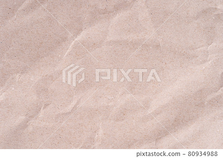 Old wrinkled brown craft paper poster texture. Blank creased crumpled grainy beige kraft paper textured surface. 80934988