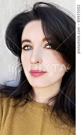 A young woman in a golden colored jumper 80935002