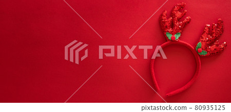 Colorful reindeer antlers headband. Holiday costume detail. Creeting card. Horn of a Christmas deer. New Year decoration on hair. Top view, flat lay, 80935125