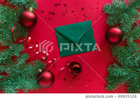 Christmas composition. Christmas letter, baubles, fir tree branches on red surface. Flat lay. Merry Christmas happy New Year concept 80935126