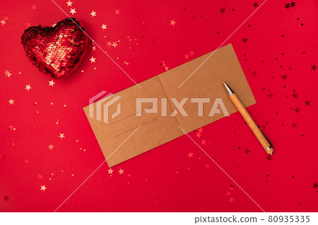 Writing a christmas letter with congratulations or congrats, pen and decorations on red surface. Merry Christmas happy New Year concept 80935335