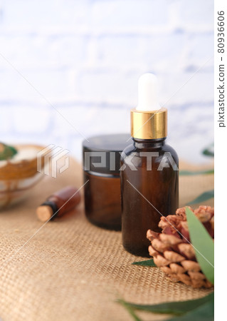 eucalyptus essential oils in a glass bottle with green leaf on white background 80936606