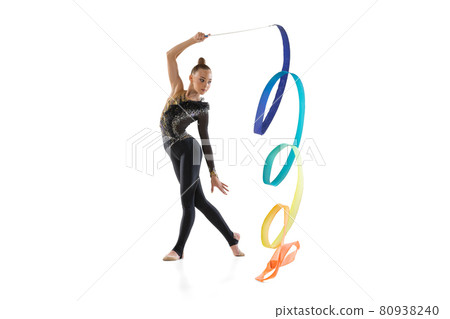 Portrait of little girl, rhythmic gymnastics artist training with colored ribbon isolated on white studio background. Concept of sport, action, aspiration Portrait of little girl, rhythmic gymnastics artist training with colored ribbon isolated on white studio background. Concept of sport, action, aspiration 80938240