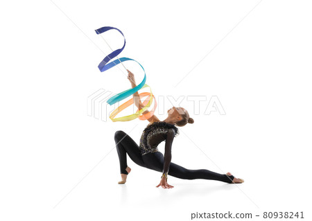Portrait of little girl, rhythmic gymnastics artist training with colored ribbon isolated on white studio background. Concept of sport, action, aspiration 80938241