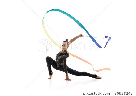 Portrait of little girl, rhythmic gymnastics artist training with colored ribbon isolated on white studio background. Concept of sport, action, aspiration 80938242