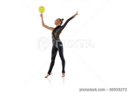 Portrait of little girl, rhythmic gymnastics artist isolated on white studio background. Concept of sport, action, aspiration, education, active lifestyle Portrait of little girl, rhythmic gymnastics artist isolated on white studio background. Concept of sport, action, aspiration, education, active lifestyle 80938273
