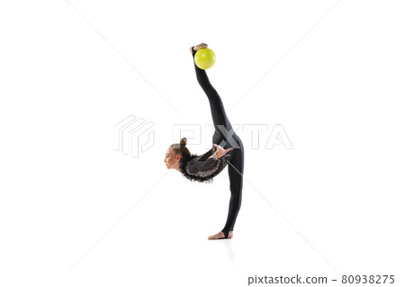 Young female athlete, rhythmic gymnastics artist isolated on white studio background. Beautiful girl practicing with ball. Concept of sport, action, aspiration Young female athlete, rhythmic gymnastics artist isolated on white studio background. Beautiful girl practicing with ball. Concept of sport, action, aspiration 80938275
