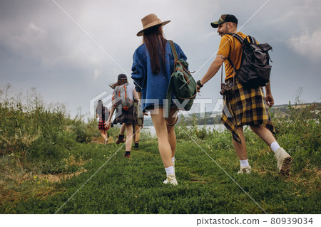 Young man and woman, family couple walking, strolling together outskirts of city, at summer forest. Active lifestyle, travel, eco, relationship concept Young man and woman, family couple walking, strolling together outskirts of city, at summer forest. Active lifestyle, travel, eco, relationship concept 80939034